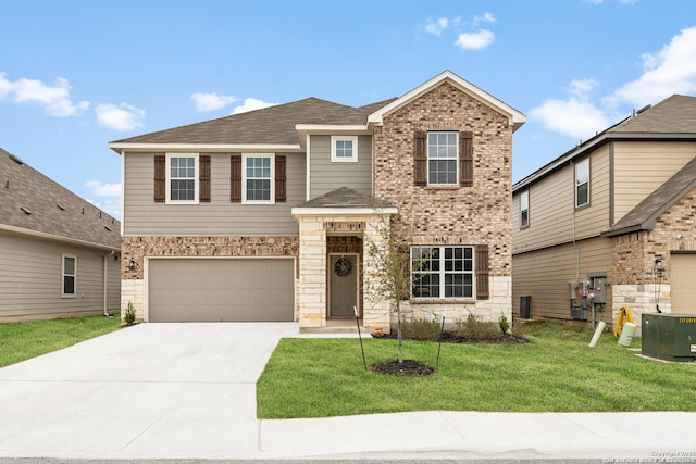 traditional home featuring driveway, an attached garage, central air condition unit, a front yard, and brick siding