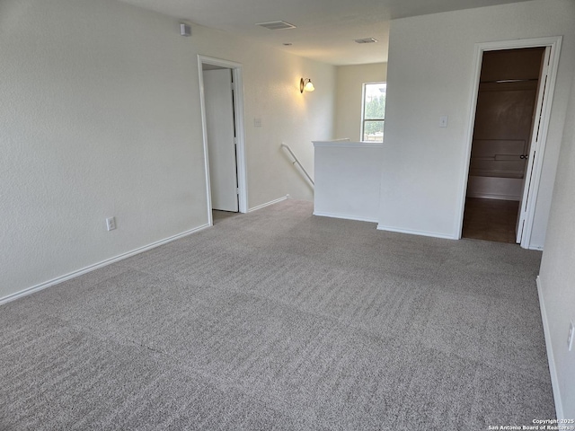 carpeted empty room with baseboards