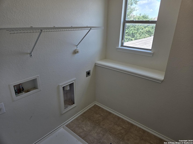 clothes washing area featuring laundry area, washer hookup, electric dryer hookup, and baseboards