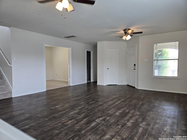 unfurnished living room with wood finished floors, visible vents, baseboards, and stairs