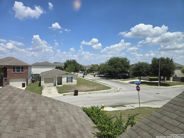 view of road featuring traffic signs, curbs, and sidewalks