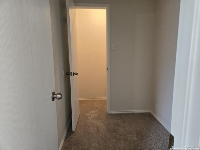 corridor featuring carpet floors and baseboards