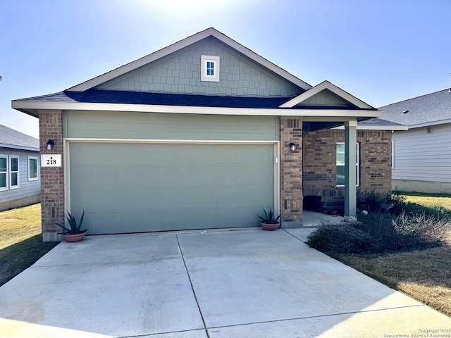 view of front of house with concrete driveway, brick siding, and an attached garage