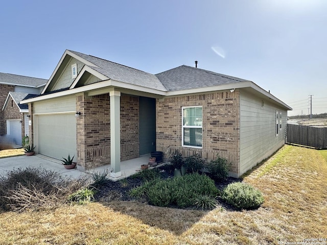 view of front of home featuring concrete driveway, brick siding, an attached garage, and roof with shingles