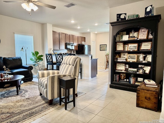 living area featuring baseboards, visible vents, a ceiling fan, light tile patterned flooring, and recessed lighting