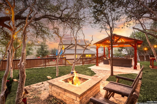 view of jungle gym featuring a fire pit, a gazebo, a patio, and a fenced backyard