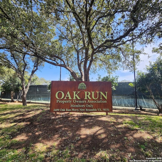 community sign featuring fence