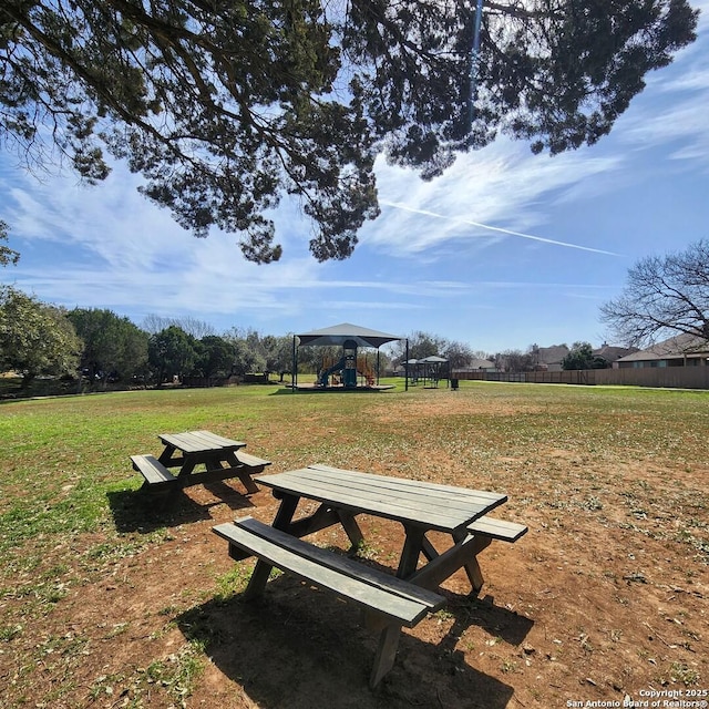 view of community with playground community and a yard