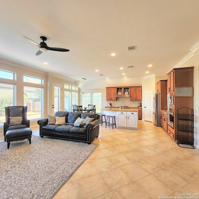 living area featuring recessed lighting, visible vents, ceiling fan, ornamental molding, and light tile patterned flooring