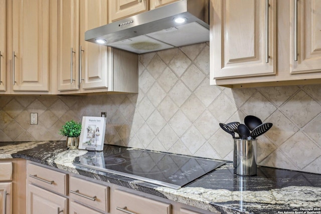 kitchen with tasteful backsplash, stone countertops, black electric cooktop, and exhaust hood