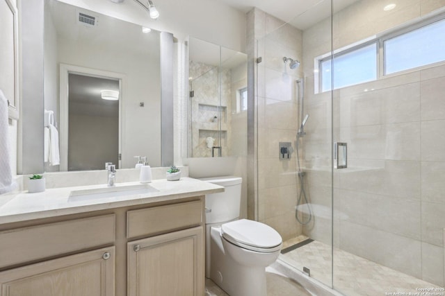 full bathroom with toilet, a stall shower, visible vents, and vanity