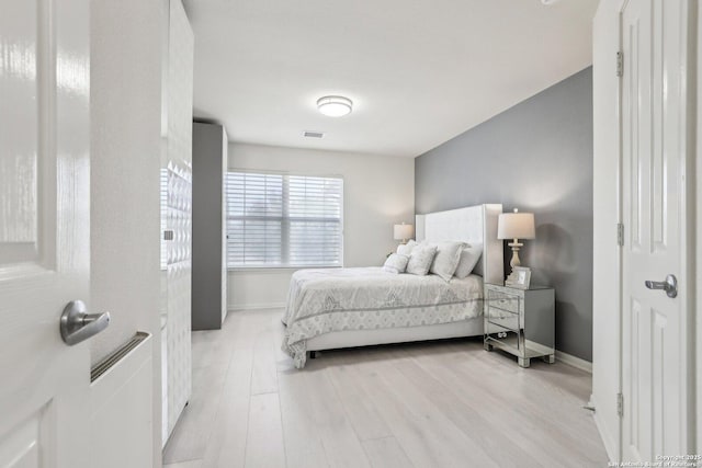 bedroom with baseboards and light wood-style floors