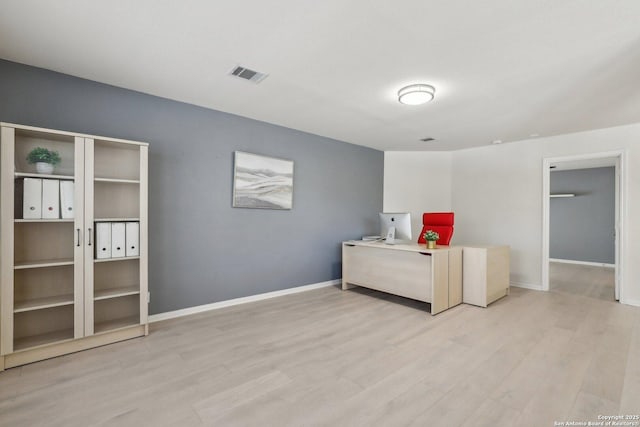 bedroom with wood finished floors, visible vents, and baseboards