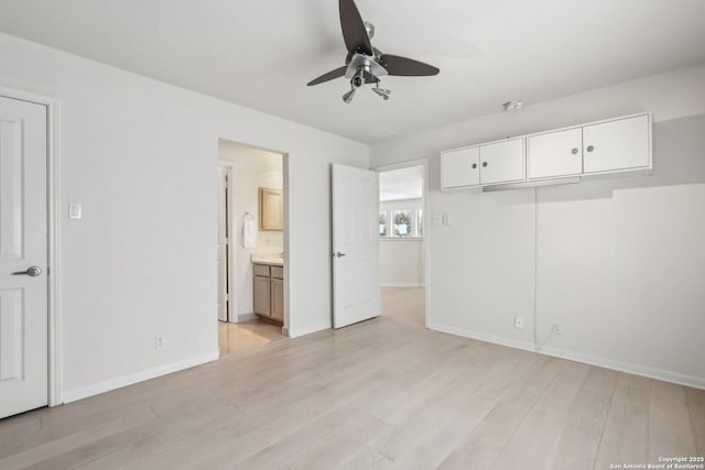 unfurnished bedroom with ceiling fan, light wood-type flooring, connected bathroom, and baseboards