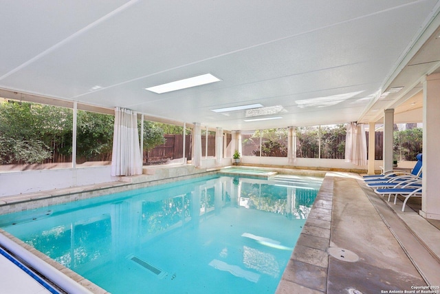 view of pool featuring a fenced backyard, a pool with connected hot tub, and a patio