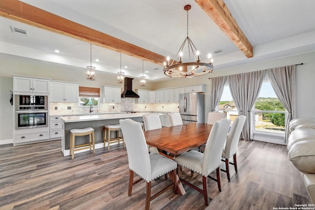 dining area with dark wood-type flooring, beam ceiling, and visible vents