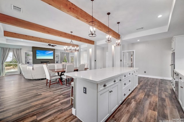 kitchen with visible vents, white cabinets, dark wood-style flooring, and light countertops