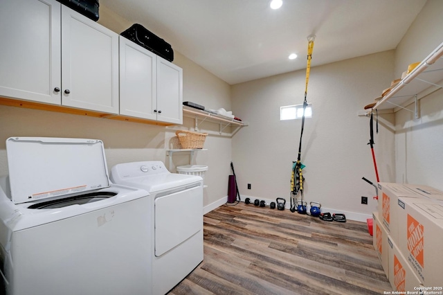 laundry area featuring cabinet space, baseboards, wood finished floors, washing machine and dryer, and recessed lighting