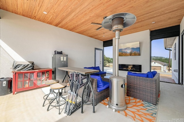 bar featuring a ceiling fan and wooden ceiling