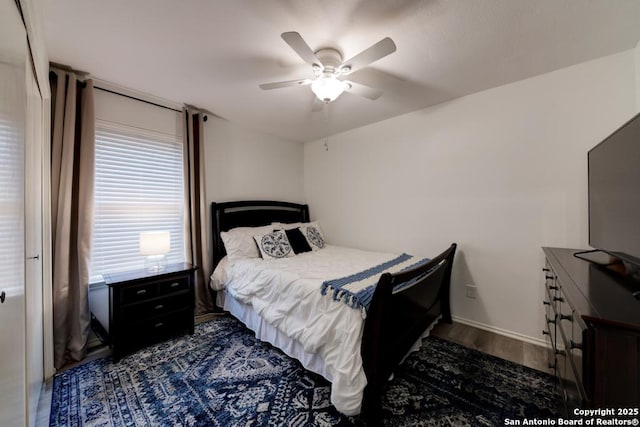 bedroom with dark wood finished floors and ceiling fan