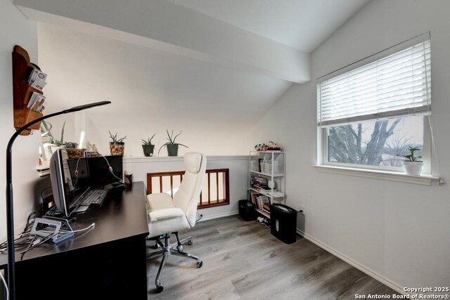 office space with vaulted ceiling, wood finished floors, and baseboards