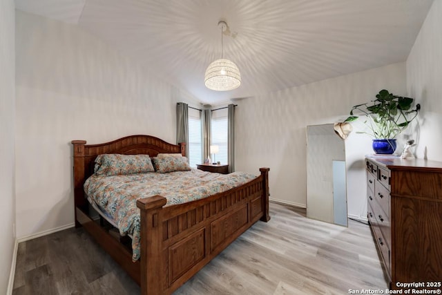 bedroom featuring baseboards and light wood finished floors