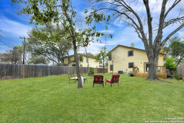 view of yard with a fenced backyard and a wooden deck