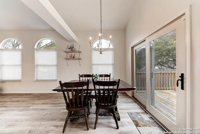 dining space featuring light wood-style floors and an inviting chandelier