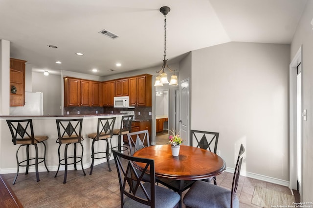 dining area with lofted ceiling, recessed lighting, visible vents, and baseboards