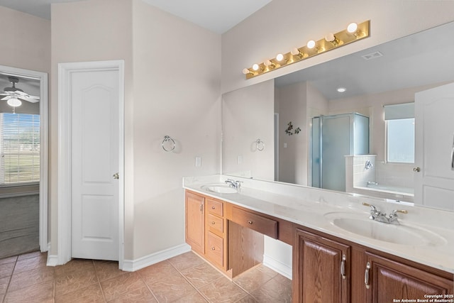 full bath with double vanity, a shower stall, a sink, and tile patterned floors