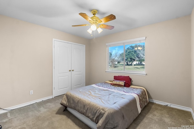 bedroom with carpet floors, a closet, ceiling fan, and baseboards