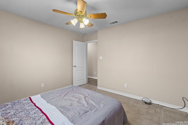 carpeted bedroom with a ceiling fan, visible vents, and baseboards