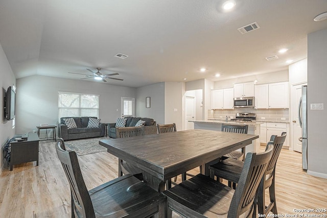 dining area with light wood-style flooring, visible vents, a ceiling fan, and recessed lighting