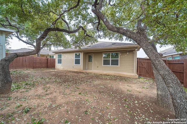 back of house featuring a fenced backyard