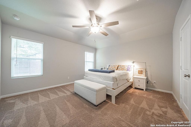 bedroom with light carpet, a ceiling fan, and baseboards