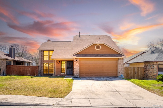 view of front facade featuring a garage, concrete driveway, fence, and a lawn