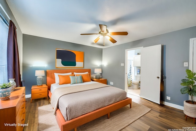 bedroom with ensuite bathroom, wood finished floors, a ceiling fan, and baseboards