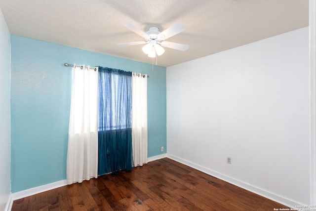 empty room with dark wood-style floors, a textured ceiling, baseboards, and a wealth of natural light