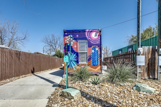 details featuring electric meter and fence