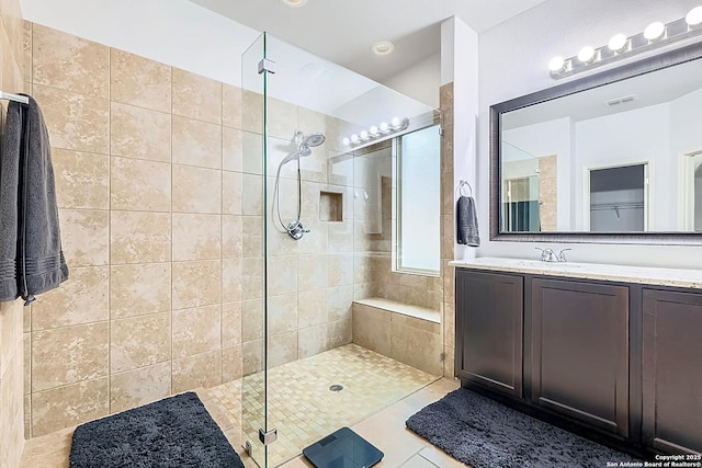 bathroom featuring a stall shower, tile patterned floors, visible vents, and vanity