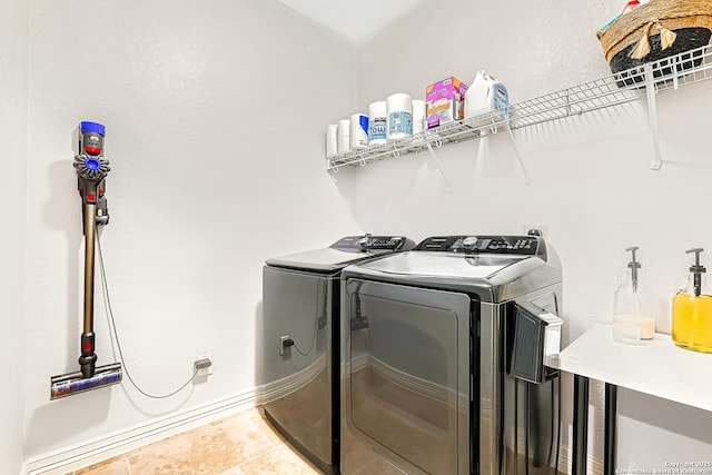 laundry room with washer and dryer, laundry area, and tile patterned floors