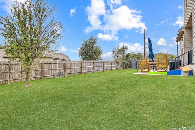 view of yard with a fenced backyard