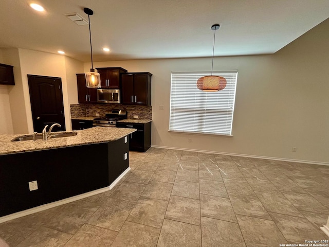 6731 Indian Ldg, San Antonio, TX 78253 - kitchen featuring decorative light fixtures, stainless steel appliances, tasteful backsplash, a sink, and light stone countertops