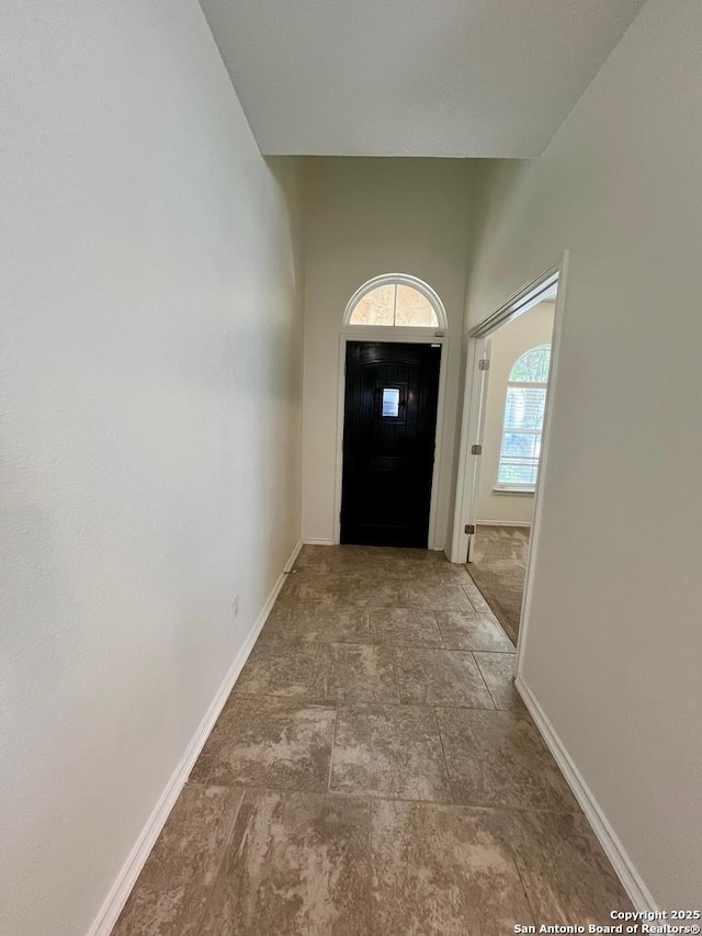 doorway to outside featuring baseboards