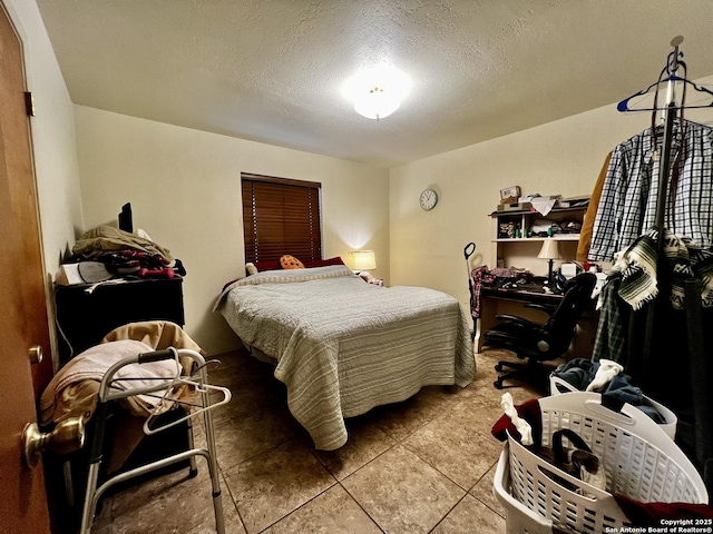 bedroom featuring tile patterned flooring and a textured ceiling