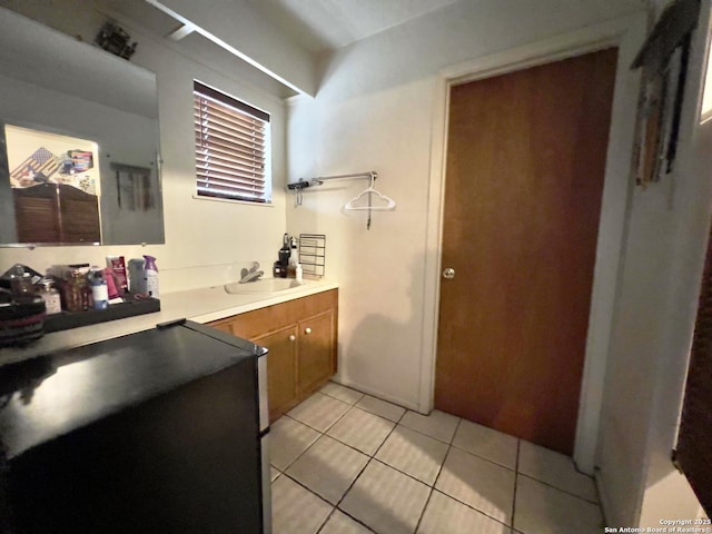 bathroom featuring tile patterned flooring and a sink