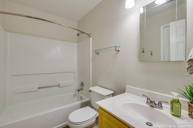 bathroom with shower / bathtub combination, a textured wall, vanity, and toilet