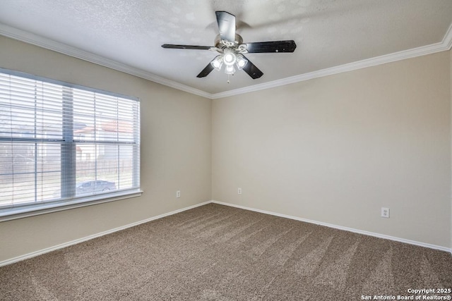 spare room featuring carpet, ornamental molding, a ceiling fan, a textured ceiling, and baseboards