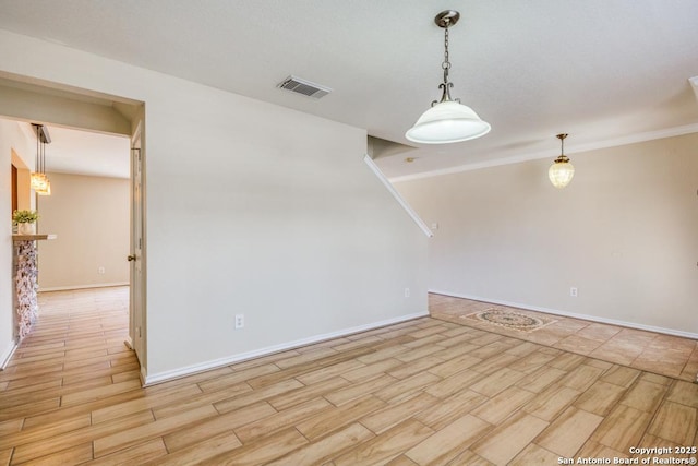 unfurnished room featuring light wood finished floors, baseboards, and visible vents