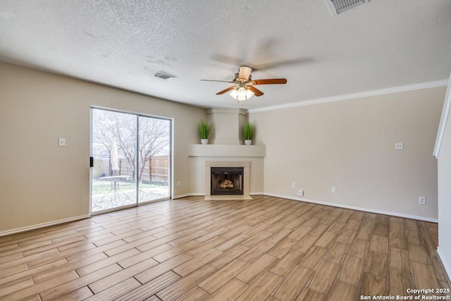 unfurnished living room with visible vents, a fireplace, and wood finished floors